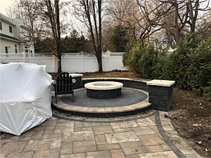 raised fire pit patio with seat wall and light piers nicolock alpine south bay
